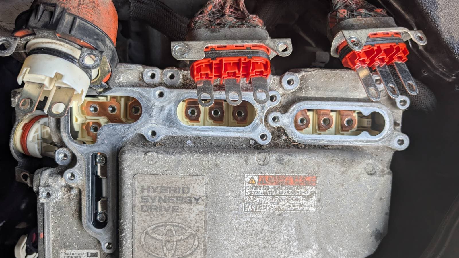 failed inverter removed, three orange high-voltage cables disconnected and visible in the empty mounting bay