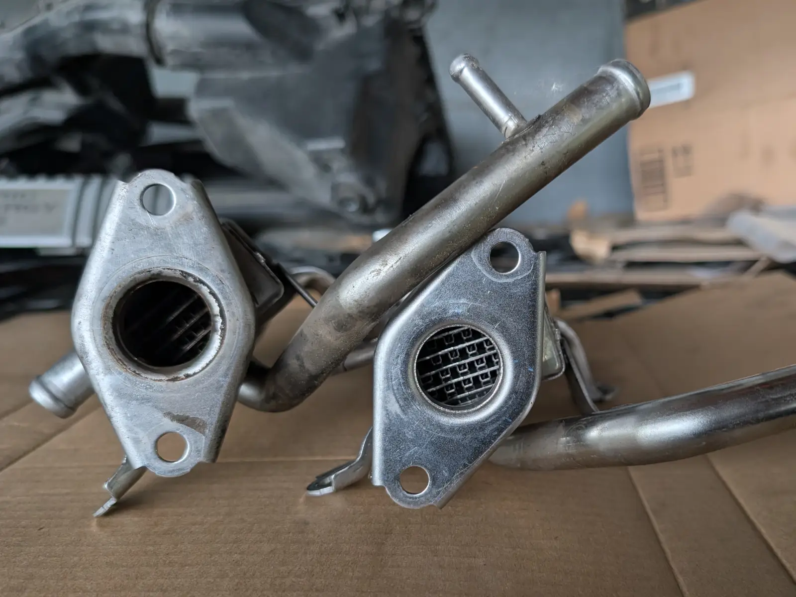 EGR valve assembly with carbon-encrusted ports on shop work surface