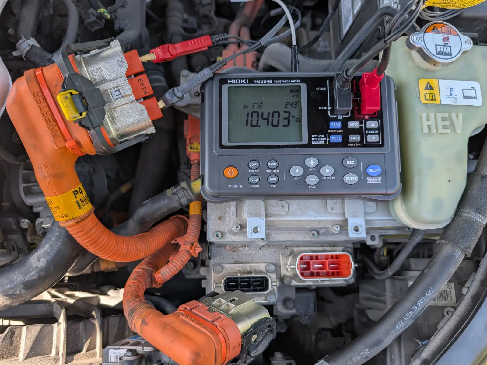 Hioki resistance meter testing inverter HV cable in hybrid engine bay